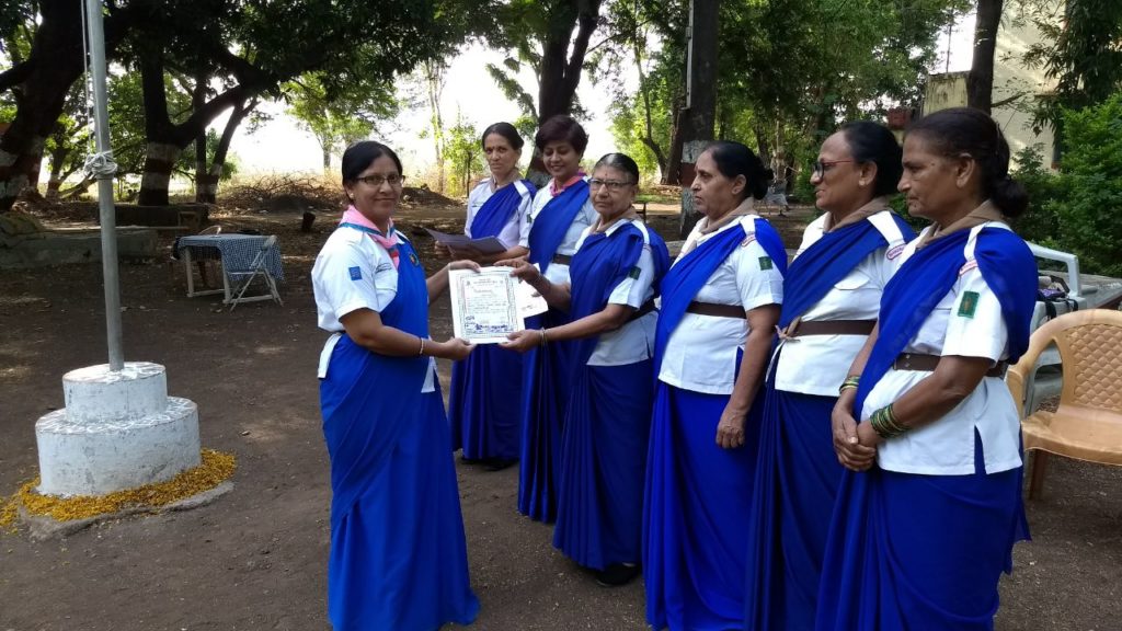 Sharon School Teacher Ms. Paras receiving the Guides Captain certificate